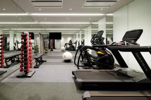 a gym with treadmills and exercise bikes in it at Courtyard by Marriott Osaka Honmachi in Osaka