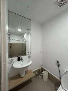 a white bathroom with a sink and a toilet at Premium Affordable Condo by Premium Living in Iloilo City