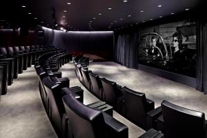 a row of chairs in a theater with a long table at Bvlgari Hotel London in London +97 photos