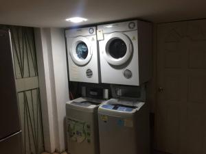 a washer and dryer in a room with two machines at Master Room at Orchard Road in Singapore