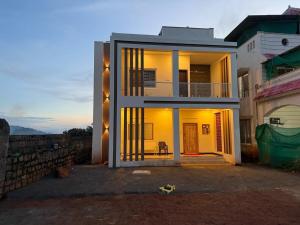 a house with the lights on in front of it at The Forest Grove by Living Circle in Yelagiri