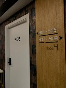 a door with numbers on it next to a wall at MM Boutique Hotel in Burgas