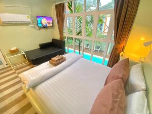 a bedroom with a large bed and a window at Hy-resort in Bangsaen +218 photos