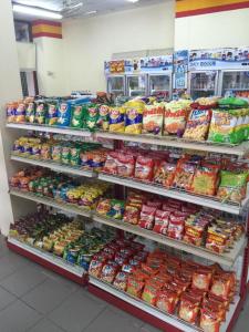 a grocery store aisle with a display of food at Kulwadee Hotel in Si Sa Ket