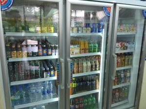 a refrigerator filled with lots of different types of drinks at Kulwadee Hotel in Si Sa Ket