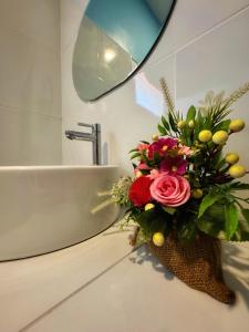 a bouquet of flowers sitting on a counter in a bathroom at Twocans Garden Village KohMak in Ko Mak +12 photos