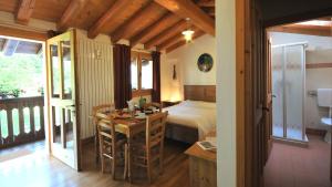 a bedroom with a bed and a desk and a table at La Nicchia in Tarzo