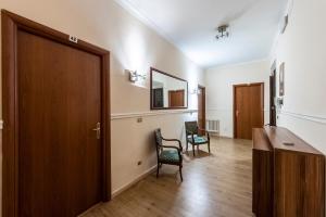 a hallway with a door and two chairs in a room at Hotel California in Rome