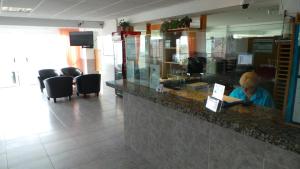 a person sitting at a counter in a restaurant at Apartamentos Beni-Beach in Benidorm +53 photos