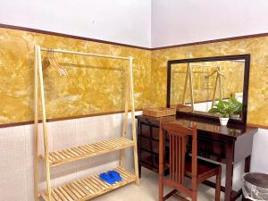 a desk with a mirror and a table with a chair at Mekong INN in Can Tho