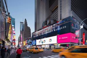 a busy city street with taxis and pedestrians and buildings at New York Marriott Marquis in New York