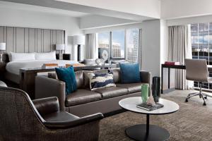 a hotel room with a couch and a bed at New York Marriott Marquis in New York