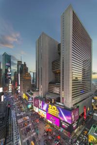 a busy city street filled with traffic in front of tall buildings at New York Marriott Marquis in New York