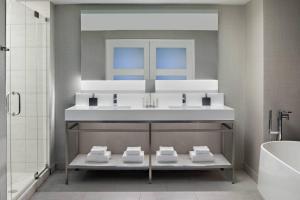 a bathroom with a sink and a bath tub at New York Marriott Marquis in New York