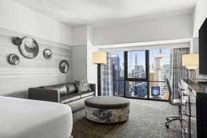 a hotel room with a bed and a couch at New York Marriott Marquis in New York