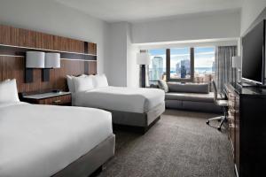 a hotel room with two beds and a television at New York Marriott Marquis in New York