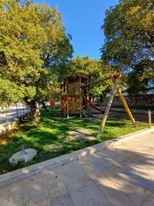 a playground with a slide in a park at Loni in Klenovica
