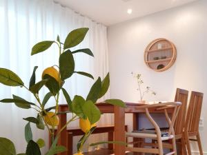 a dining room with a table and a plant at Dal126 House Seoul in Seoul