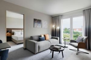 a living room with a couch and a bed at Courtyard by Marriott Munich City East in Munich +37 photos