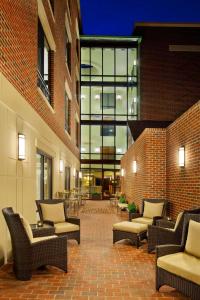 a patio with chairs and tables and a building at Courtyard Fredericksburg Historic District in Fredericksburg