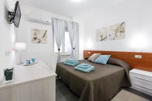 a bedroom with a bed with blue towels on it at Roma Trastevere Relais Guest House in Rome