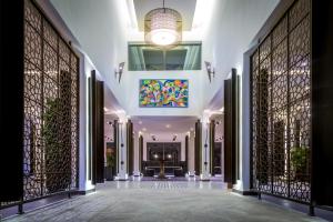 a hallway of a building with gates and a chandelier at Azala&iuml; H&ocirc;tel Nouakchott in Nouakchott