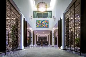 a hallway of a building with gates and a chandelier at Azalaï Hôtel Nouakchott in Nouakchott