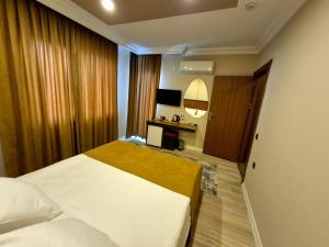 Postel nebo postele na pokoji v ubytování Toprak Apart Otel