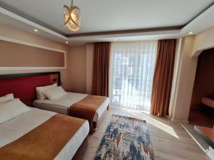 Postel nebo postele na pokoji v ubytování Toprak Apart Otel