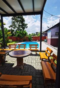 un grupo de bancos alrededor de una mesa y una piscina en A'Famosa Resort villa with Private Swimming pool, en Kampong Pulau Sebang 10 fotos más