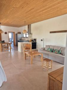 a living room with a couch and a table at Villa Lavayarena private pool in Lajares in La Oliva