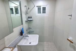 a white bathroom with a sink and a mirror at Dal126 House Seoul in Seoul +39 photos