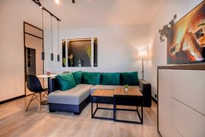 a living room with a couch and a table at Apartament Lwowska Faktura Vat in Nowy Sącz