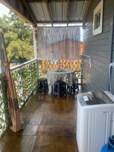 a screened in porch with a table and chairs at cabaña NFF in Punta Del Diablo +21 photos