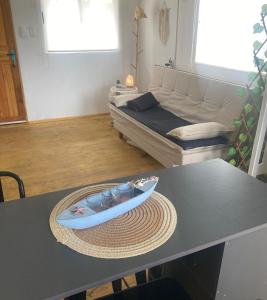 a living room with a table with a surfboard on it at cabaña NFF in Punta Del Diablo