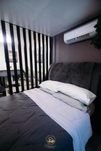a bed in a room with a large window at Philippine Arena Staycation in Marilao Bulacan in Marilao