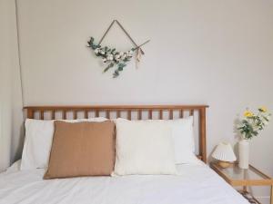 a bedroom with a bed with a clock on the wall at Dal126 House Seoul in Seoul
