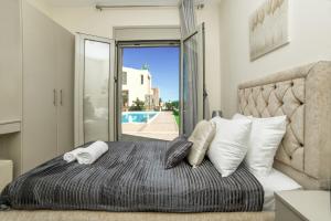 a bedroom with a large bed with white pillows at Aroma Villas in Hersonissos +105 photos