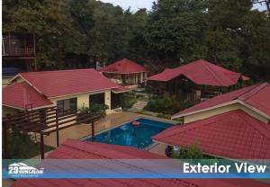 an aerial view of a house with red roofs at Tiara Boutique Villa By 29 Bungalow in Alibaug