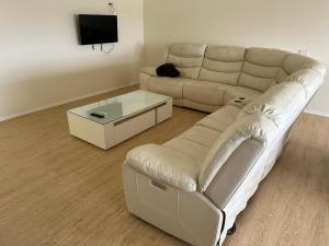 a living room with a couch and a coffee table at The White House Apartment in Tokoroa