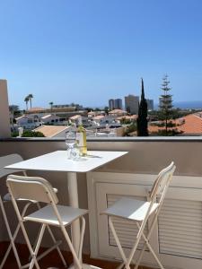 a white table and chairs on a balcony with a view at Carlos in Callao Salvaje