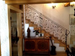 a room with a staircase with a wooden table and a stair case at Kur- und Ferienhotel Haser in Oberstaufen +134 photos