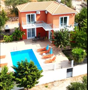 an aerial view of a house with a swimming pool at Villa Georgia in Lourdhata
