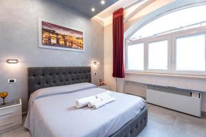 a bedroom with a large bed with two towels on it at Giulia's house Roma in Rome