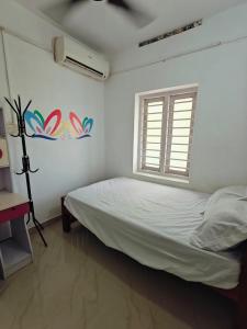 a white bedroom with a bed and a window at Heinrich Wolfi Heritage Inn in Kāyankulam +99 photos