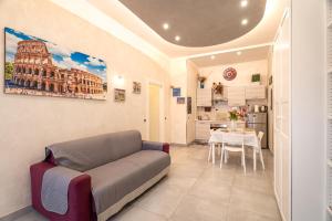 a living room with a couch and a table at Giulia's house Roma in Rome