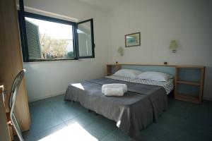 sypialnia z dwoma łóżkami i oknem w obiekcie SERENA SWEET HOUSE w mieście SantʼAndrea Apostolo dello Ionio +37 zdjęć
