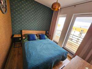 Postel nebo postele na pokoji v ubytování VIP Apartament-Marine