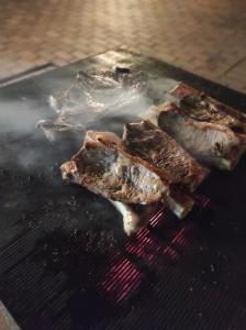 two pieces of meat cooking on a grill at Terrace Sands Guesthouse in Durban