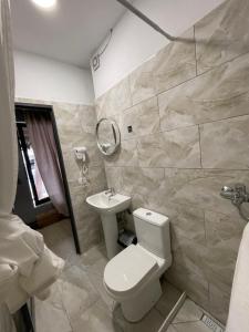 a bathroom with a toilet and a sink at Destination Central Room 2 in Tirana
